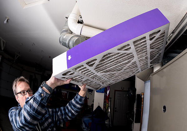 Man changing a furnace filter